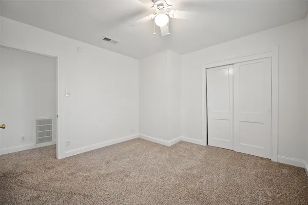 a view of an empty room with a fan