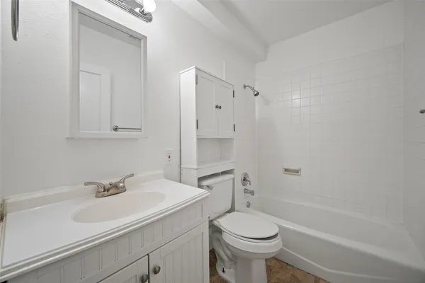 a bathroom with a sink a toilet and a bathtub