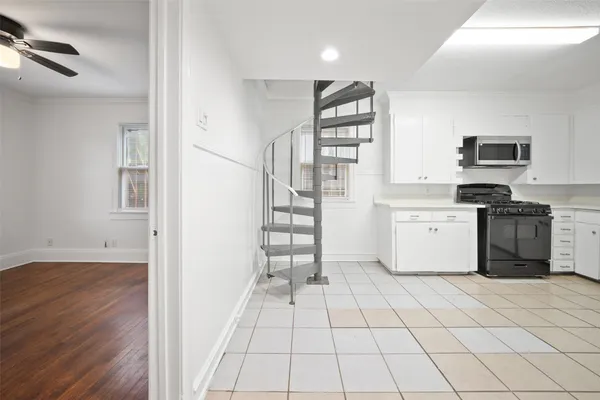 a kitchen with a stove a sink and a refrigerator