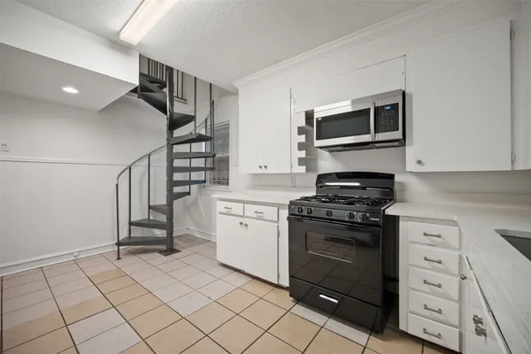 a kitchen with a stove and a microwave