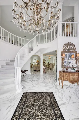a view of a dining room with furniture and chandelier