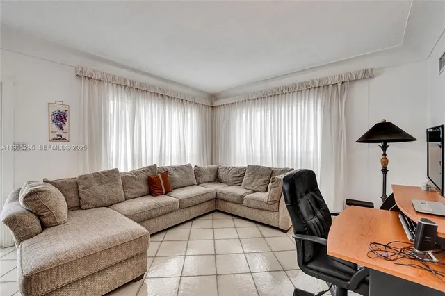 a living room with furniture large window and a table