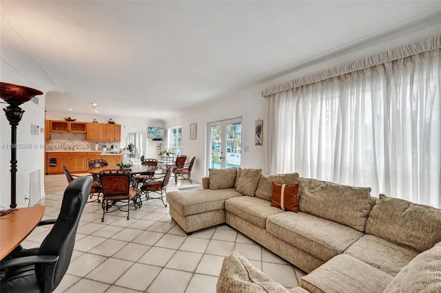 a large bedroom with a bed and a refrigerator