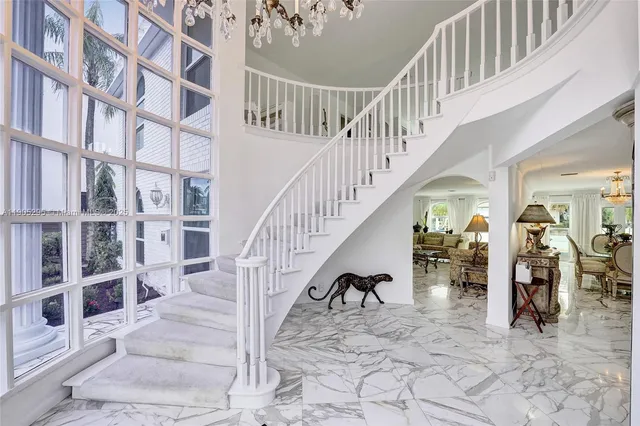 a dining room with furniture a chandelier and wooden floor