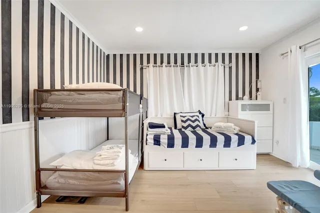 a bed sitting in a bedroom next to a window