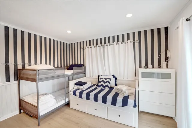 a bedroom with a bed and a refrigerator