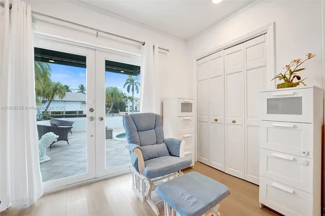 a living room with a bed furniture and a window