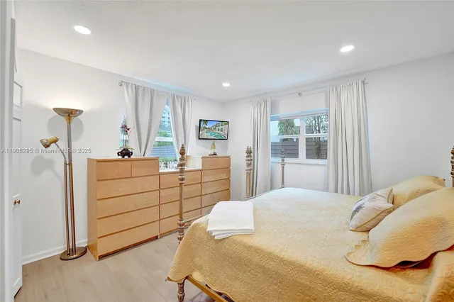 a large bedroom with a large bed and a large window