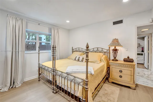 a spacious bedroom with a bed and a couch