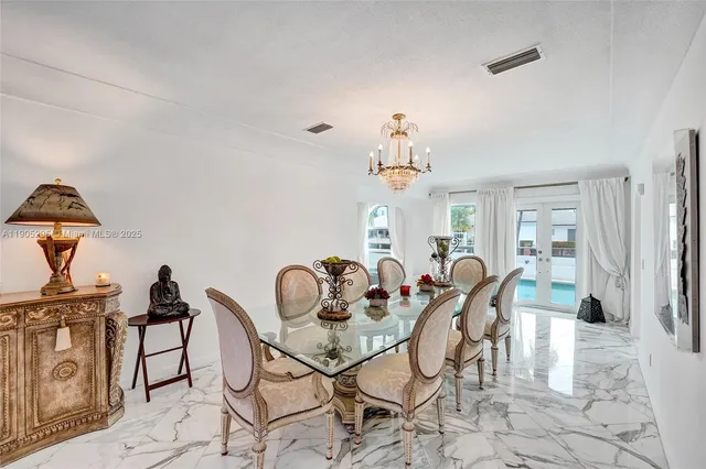 a living room with furniture flowerpot and wooden floor