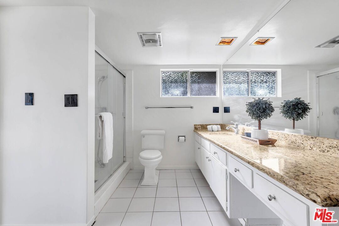 2050 Glentree Drive Lomita, CA 90717 - Photo 17 of 36 a spacious bathroom with a granite countertop sink toilet and mirror