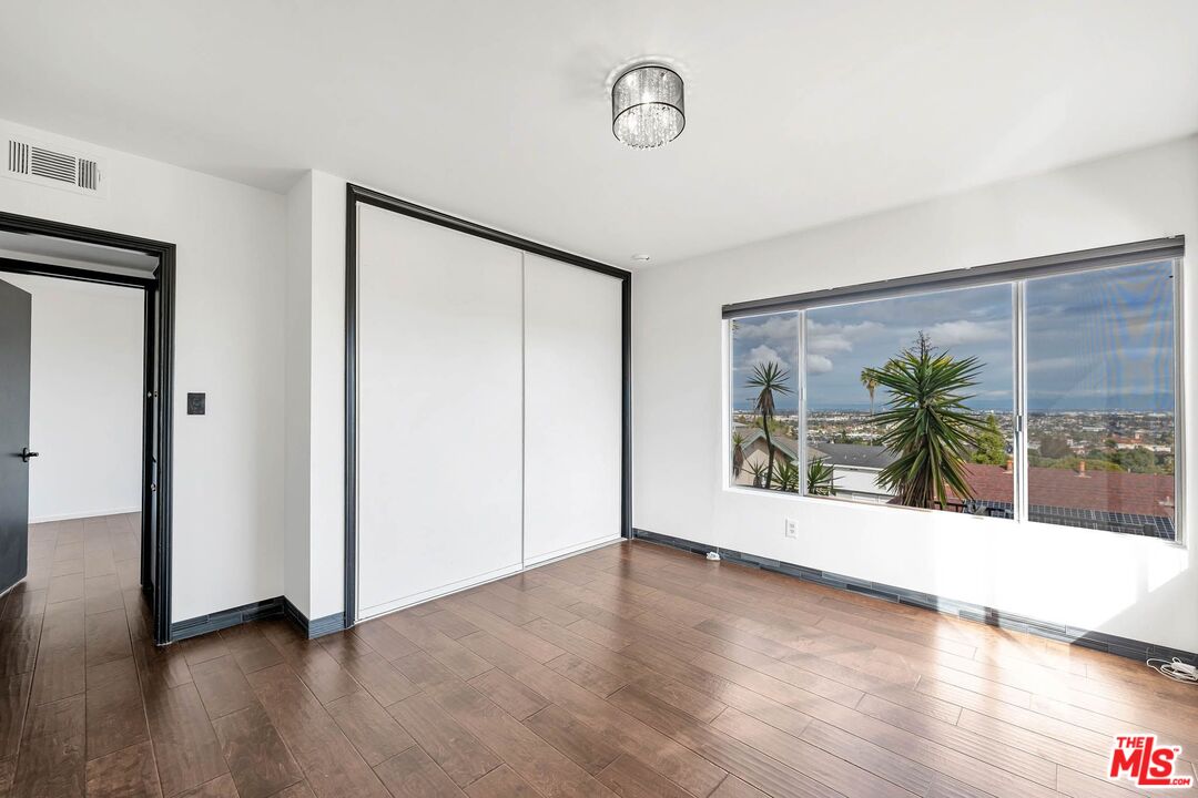 2050 Glentree Drive Lomita, CA 90717 - Photo 19 of 36 a view of a room with wooden floor and a large window