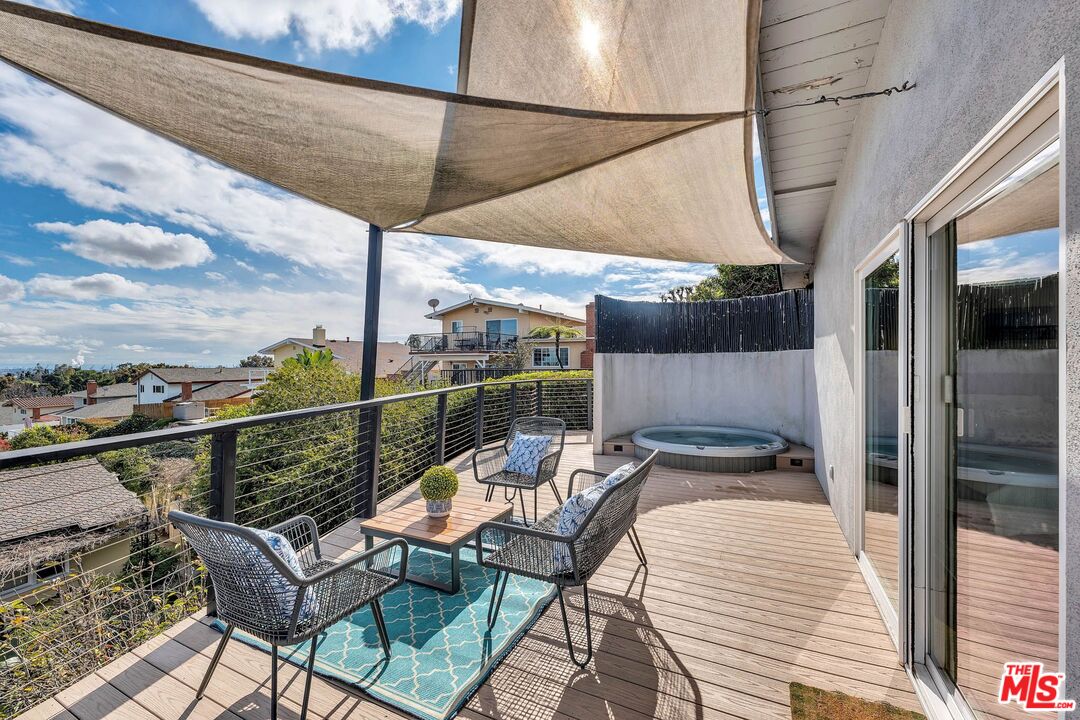2050 Glentree Drive Lomita, CA 90717 - Photo 26 of 36 a view of a balcony with chairs and wooden floor