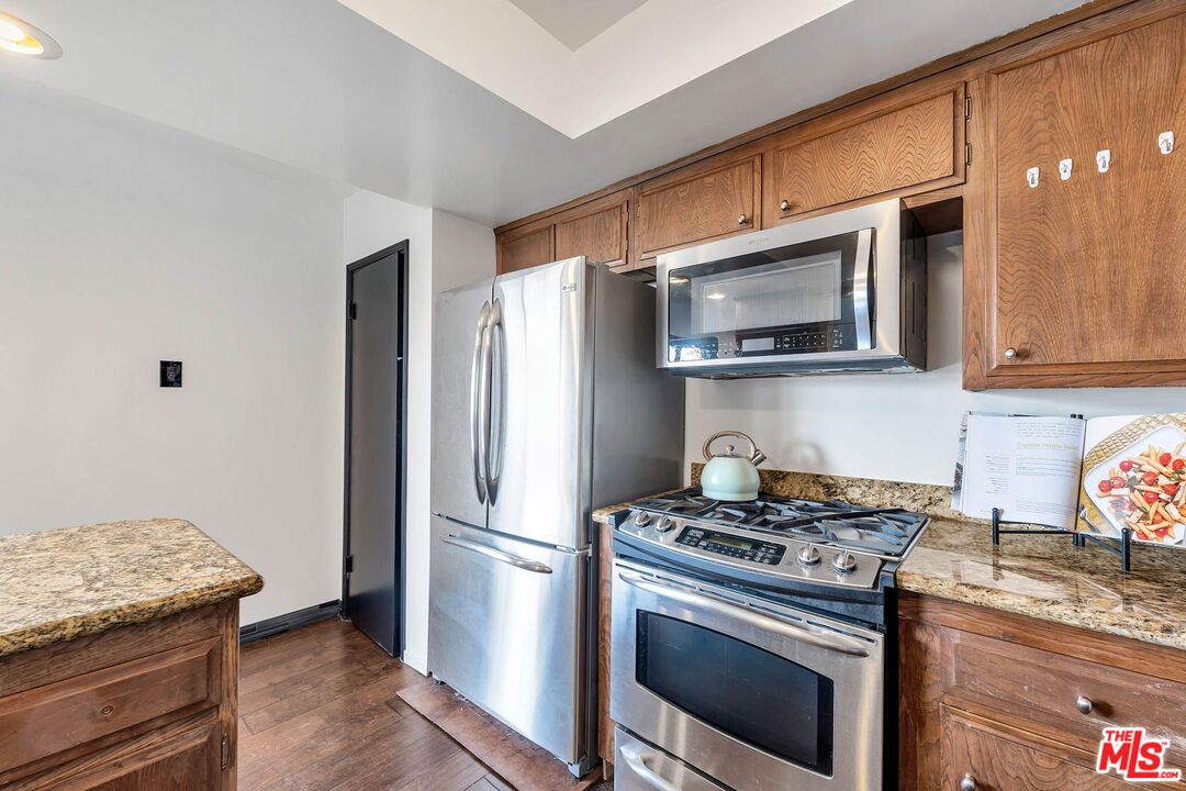 2050 Glentree Drive Lomita, CA 90717 - Photo 9 of 36 a kitchen with stainless steel appliances granite countertop a stove microwave refrigerator and sink