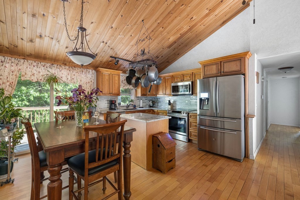 531 Fowler Road Northbridge, MA 01534 - Photo 8 of 41 a kitchen with stainless steel appliances granite countertop a refrigerator a microwave oven a sink with island and chairs