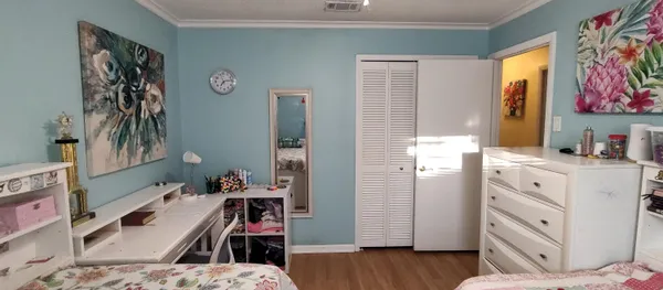 a bedroom with furniture and a window