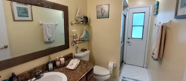 a white toilet sitting next to a bathroom sink