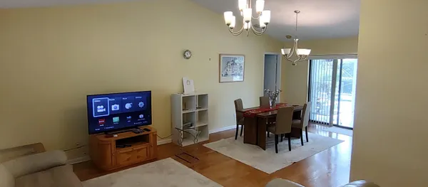 a view of a dining room with furniture and chandelier