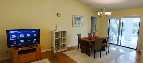 a view of a dining room with furniture and wooden floor