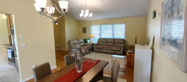 a living room with furniture and a chandelier