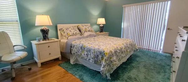 a bed room with a bed and a chandelier