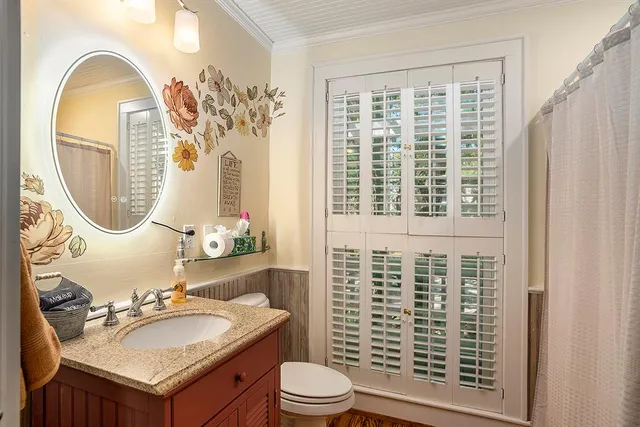a view of a room with wooden floor and windows