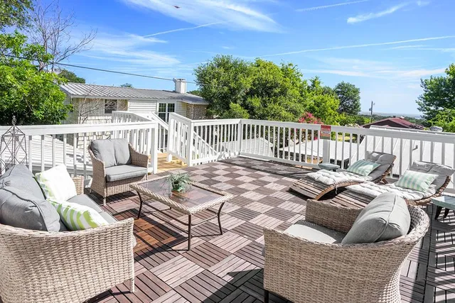 a roof deck with a table and chairs