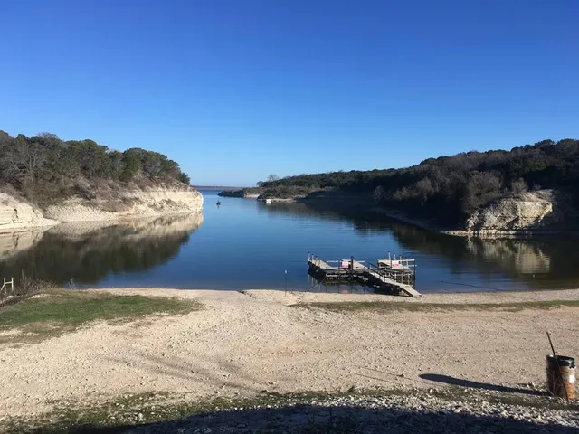 a view of a patio with table and chairs with wooden floor and fence