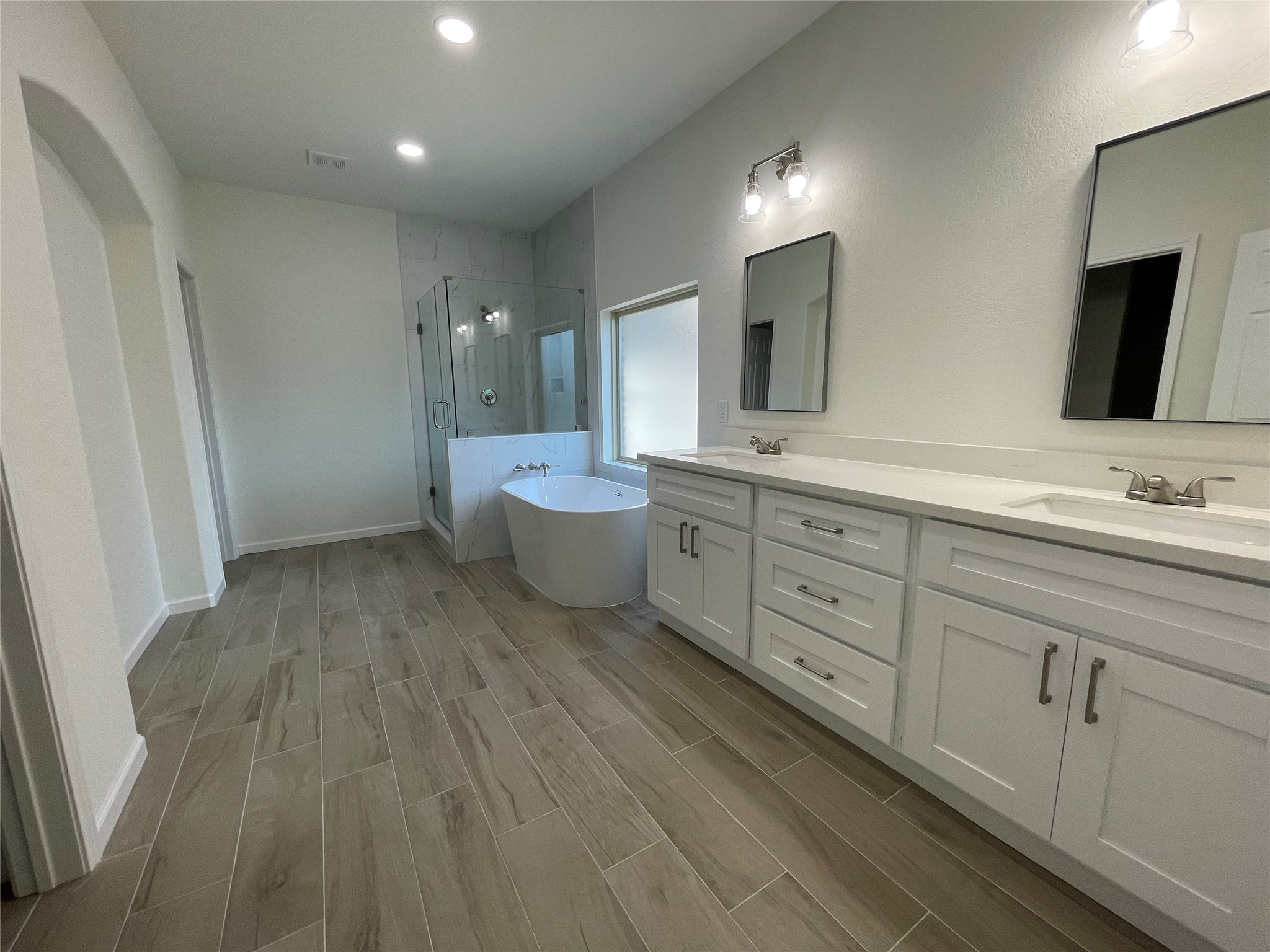 4118 Guild Meadows Drive Houston, TX 77084 - Photo 27 of 35 a spacious bathroom with double vanity sink a mirror and a toilet