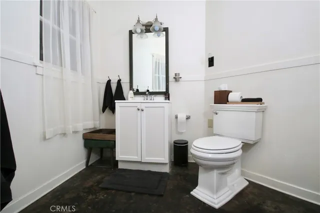 a bathroom with a toilet a sink and a mirror