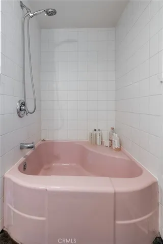 a white bath tub sitting next to a white sink