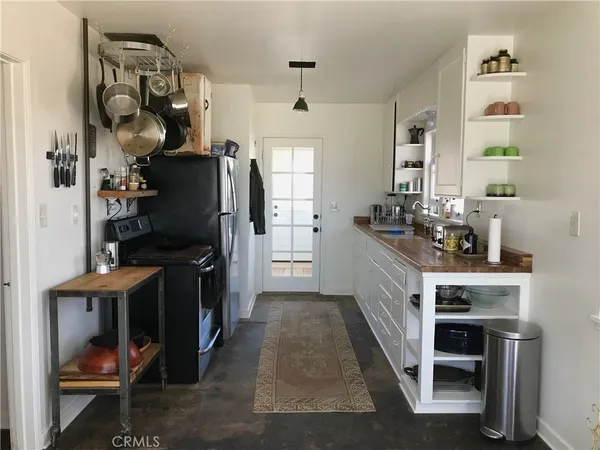 a kitchen with a sink appliances and cabinets