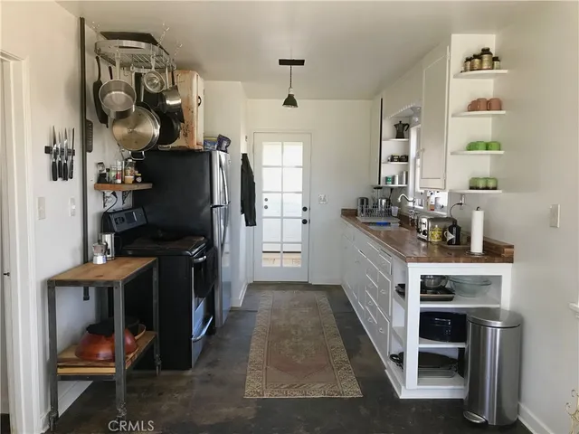 a kitchen with a sink appliances and cabinets