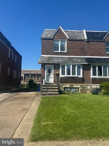 a view of a house with a yard and sitting area