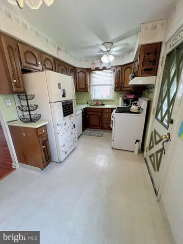 a view of empty room with window and wooden floor
