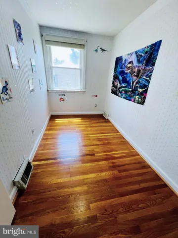 a bedroom with two beds and a dresser