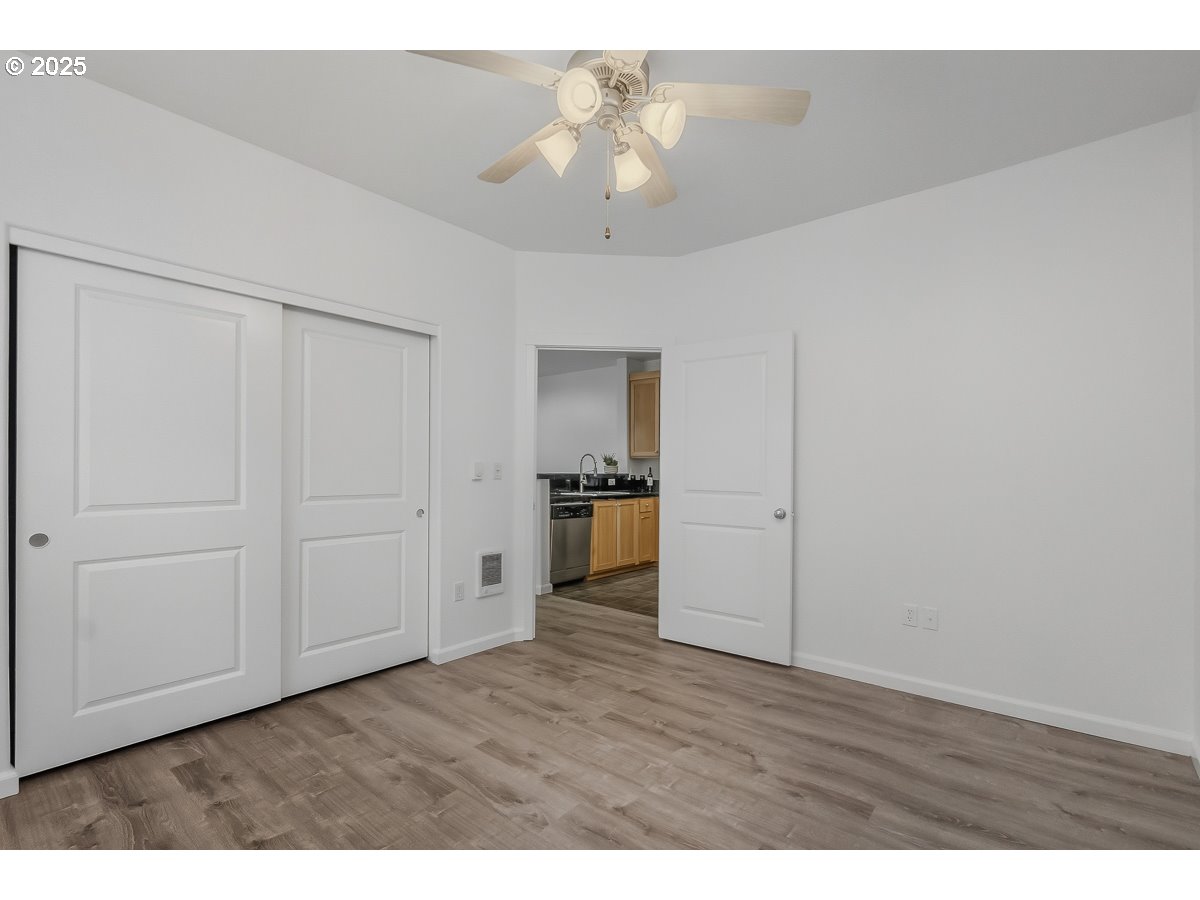 1180 Southwest 170th Avenue, Unit 100 Beaverton, OR 97003 - Photo 18 of 32 a view of an empty room and wooden floor