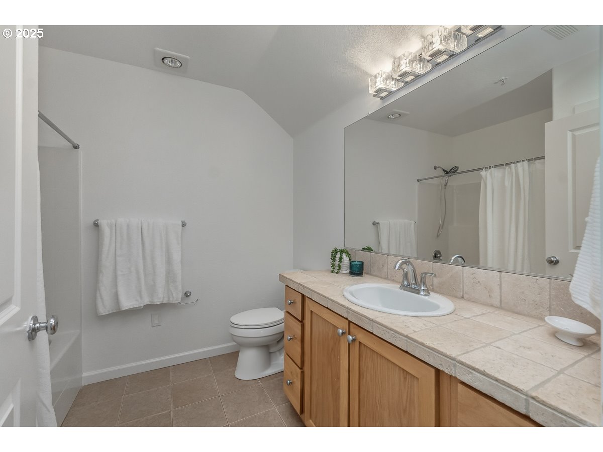 1180 Southwest 170th Avenue, Unit 100 Beaverton, OR 97003 - Photo 22 of 32 a bathroom with a sink toilet a mirror and vanity