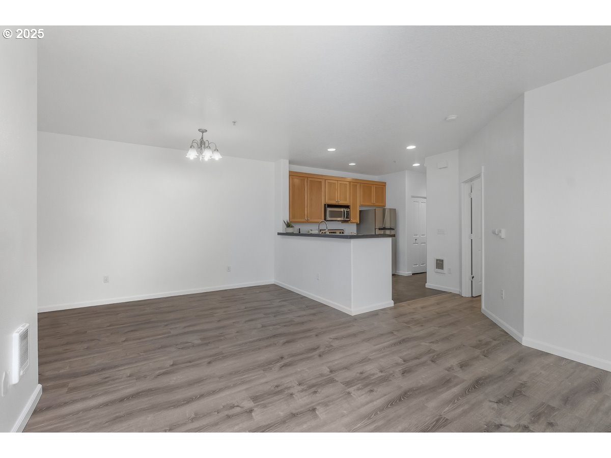 1180 Southwest 170th Avenue, Unit 100 Beaverton, OR 97003 - Photo 10 of 32 a view of kitchen and hall with wooden floor