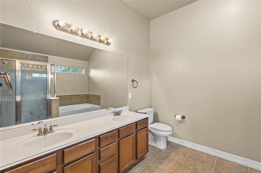 3818 Springcrest Lane Montgomery, TX 77356 - Photo 13 of 19 a bathroom with a double vanity sink mirror and toilet