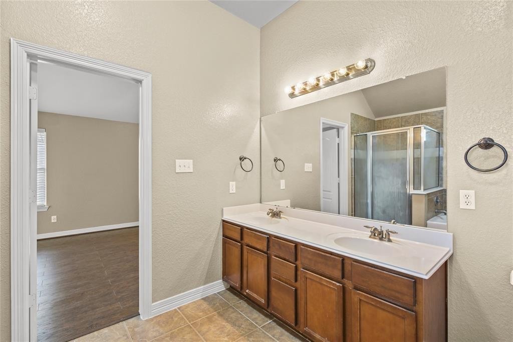 3818 Springcrest Lane Montgomery, TX 77356 - Photo 14 of 19 a spacious bathroom with a double vanity sink a mirror and a shower