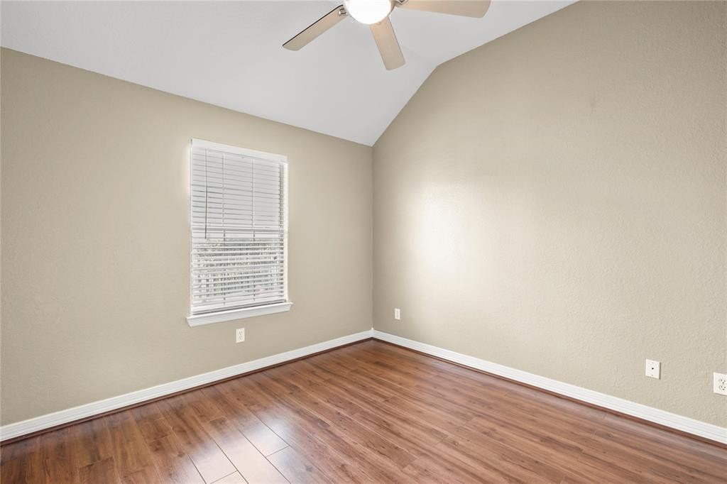 3818 Springcrest Lane Montgomery, TX 77356 - Photo 17 of 19 an empty room with wooden floor chandelier fan and windows