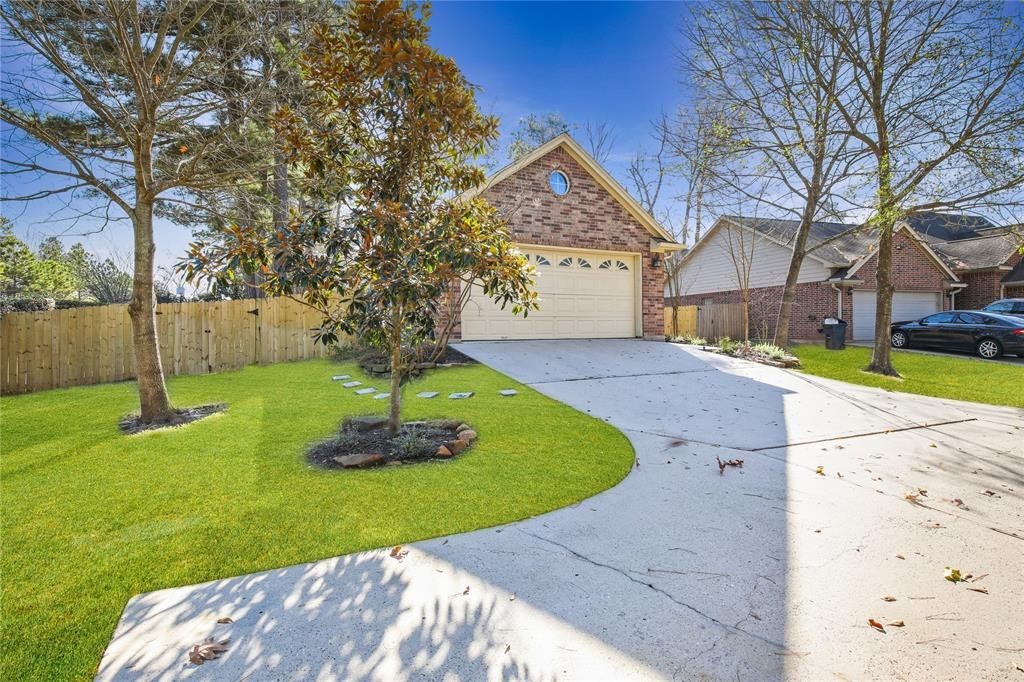 3818 Springcrest Lane Montgomery, TX 77356 - Photo 2 of 19 a front view of a house with a yard and large tree