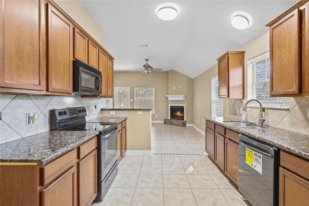 3818 Springcrest Lane Montgomery, TX 77356 - Photo 5 of 19 a kitchen with stainless steel appliances granite countertop a sink stove and cabinets