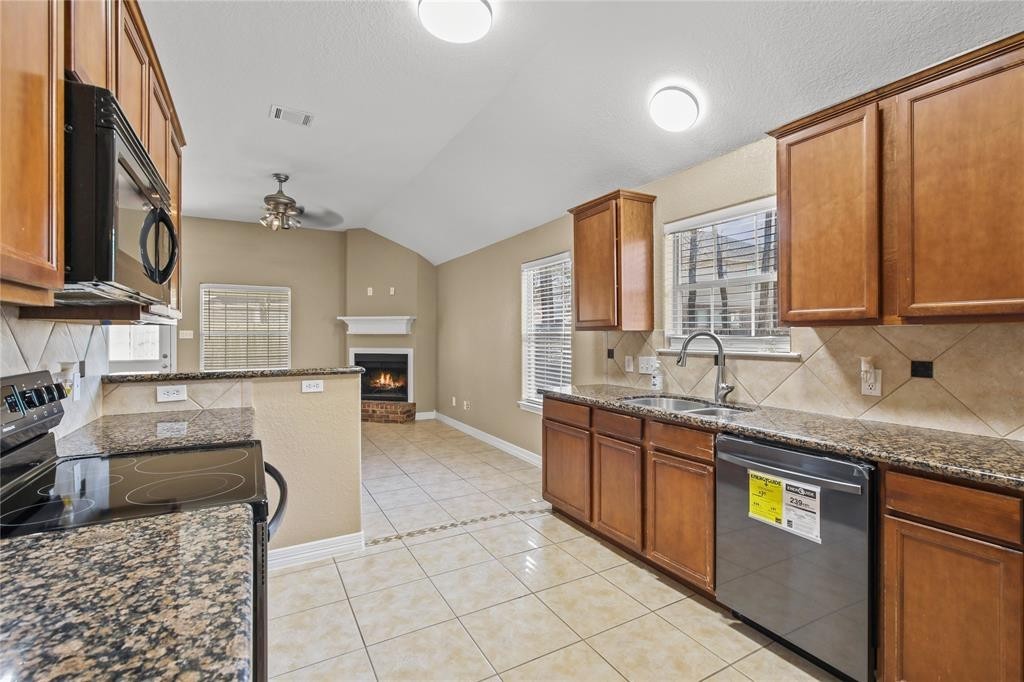 3818 Springcrest Lane Montgomery, TX 77356 - Photo 6 of 19 a large kitchen with granite countertop a sink and cabinets