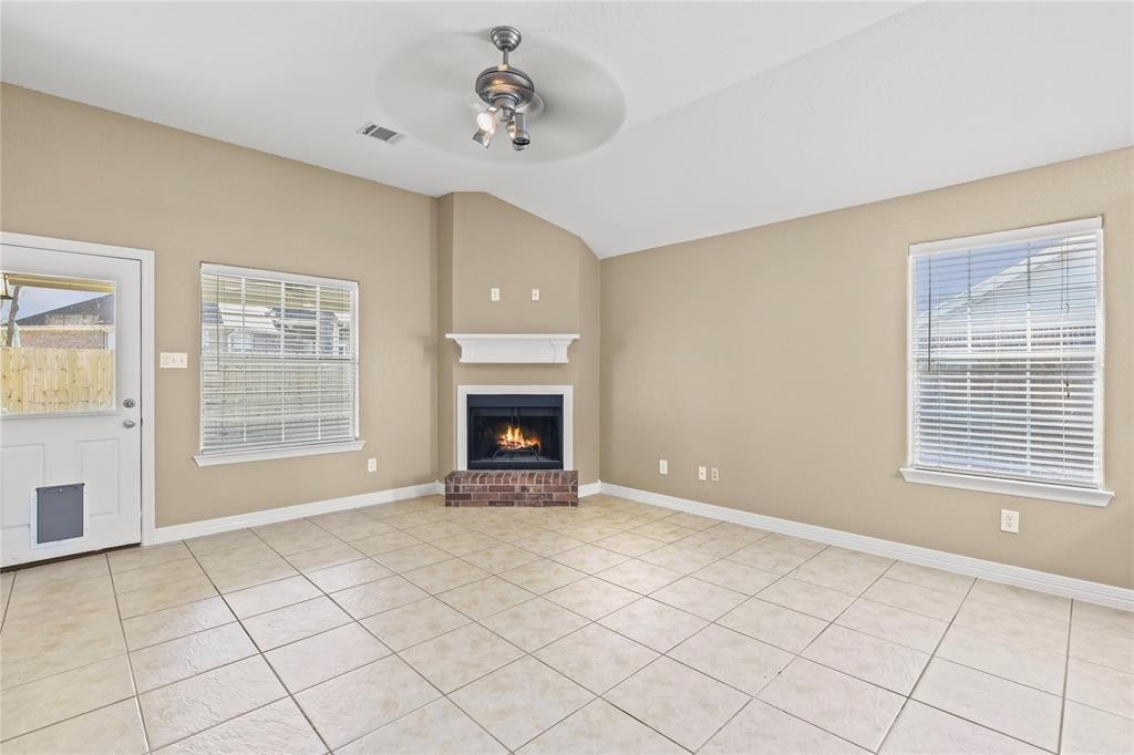 3818 Springcrest Lane Montgomery, TX 77356 - Photo 10 of 19 a view of an empty room with a fireplace and a window