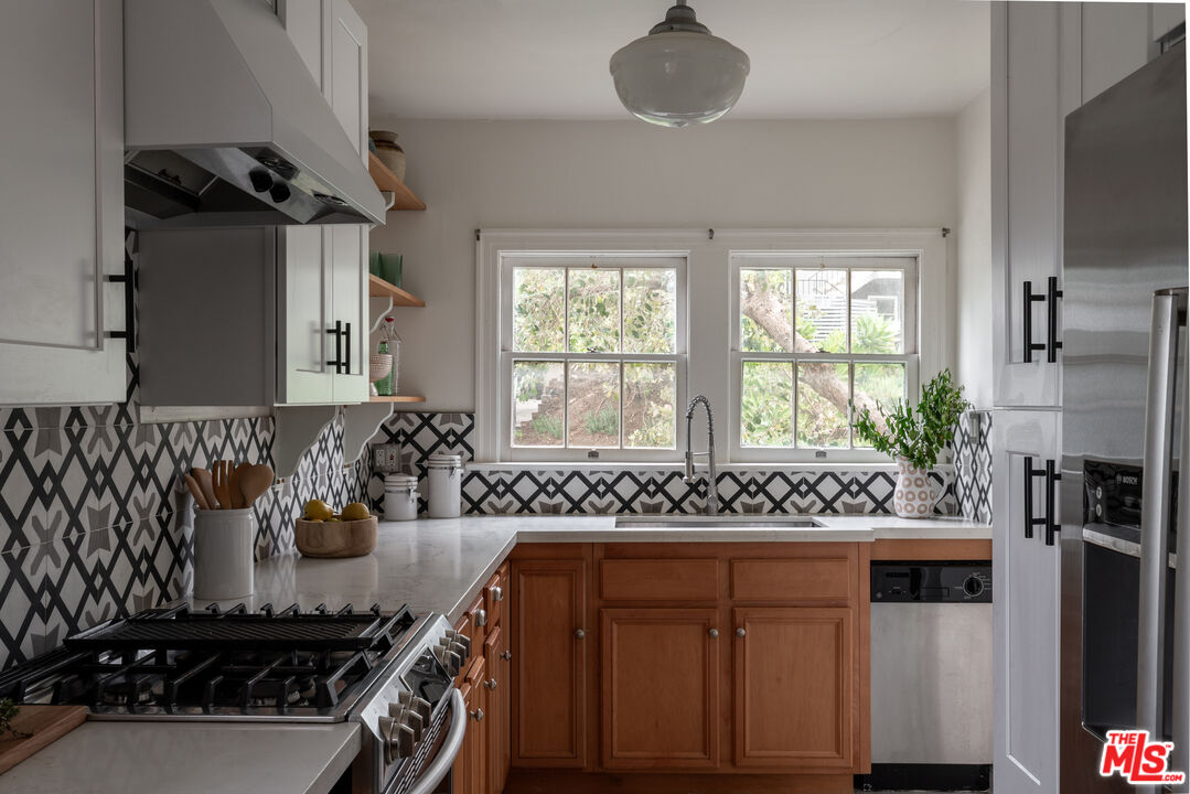 3640 Roderick Road Los Angeles, CA 90065 - Photo 14 of 27 a bathroom with a granite countertop sink a mirror and window