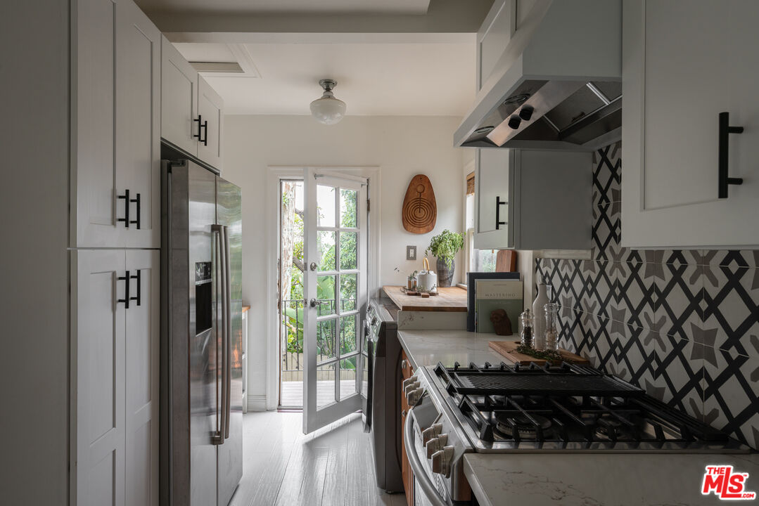 3640 Roderick Road Los Angeles, CA 90065 - Photo 16 of 27 a kitchen with a stove and a wooden floor