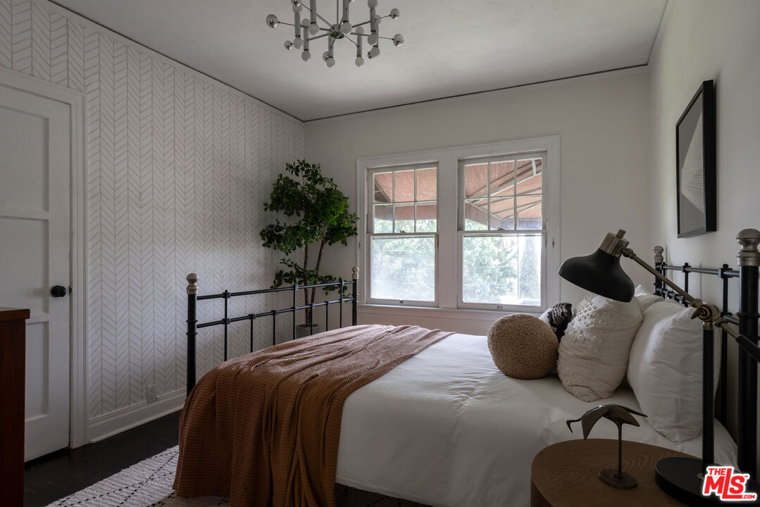 3640 Roderick Road Los Angeles, CA 90065 - Photo 20 of 27 a bedroom with a bed window and a potted plant on table