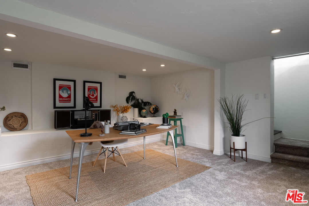 3640 Roderick Road Los Angeles, CA 90065 - Photo 22 of 27 a living room with furniture a potted plant and a large window